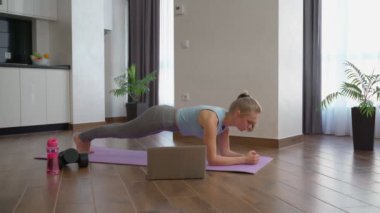 Yoga minderinin üzerinde duran kadın.