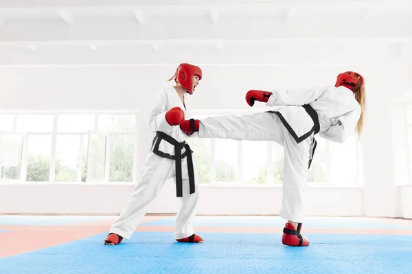 Two professional female karate fighting, using karate technique kick and punch.