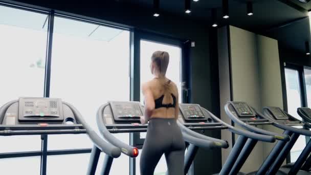 Fit woman running on treadmill. — Stock Video