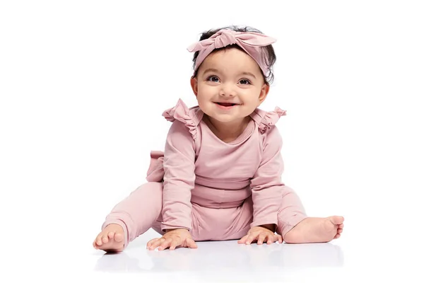 Baby girl posing on studio floor. — Stock Photo, Image