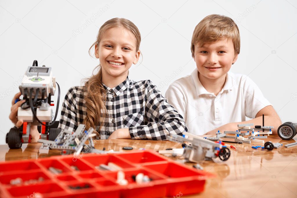 Two kids working using building kit.