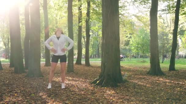 Sportieve vrouw opwarmen voor de training buiten — Stockvideo