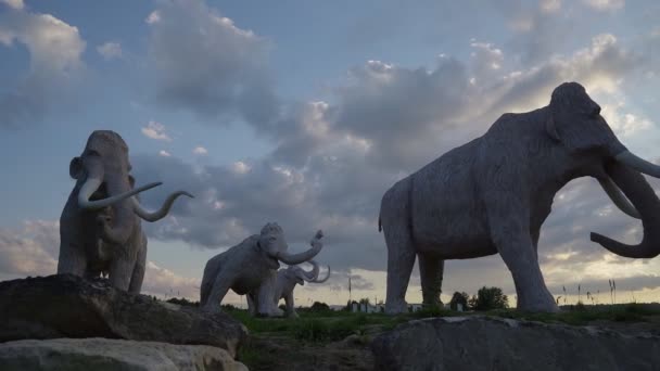 Гигантские статуи мамонтов на открытом воздухе, летний закат. — стоковое видео