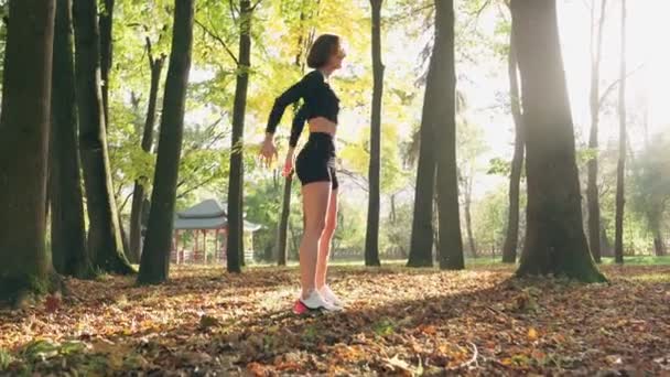 Mujer delgada haciendo sentadillas ejercicios en el parque — Vídeos de Stock