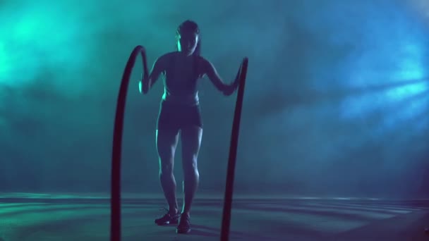 Mulher morena muscular treinando com cordas. — Vídeo de Stock