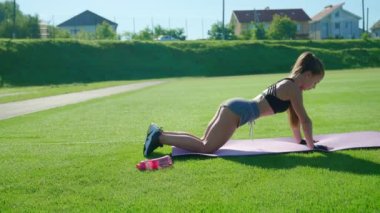 Kadın dışarıda dizlerinden şınav çekiyor..