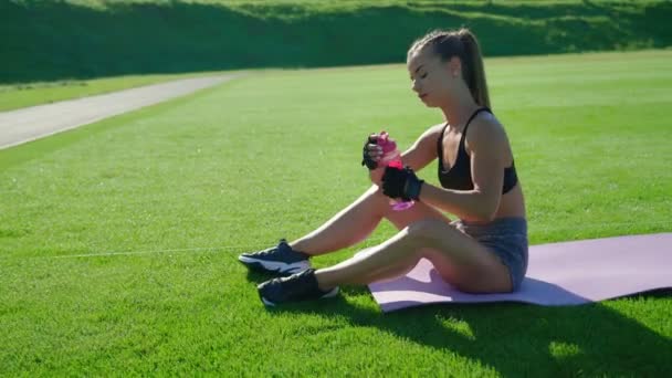 Vrouw drinkwater na de training in het stadion. — Stockvideo