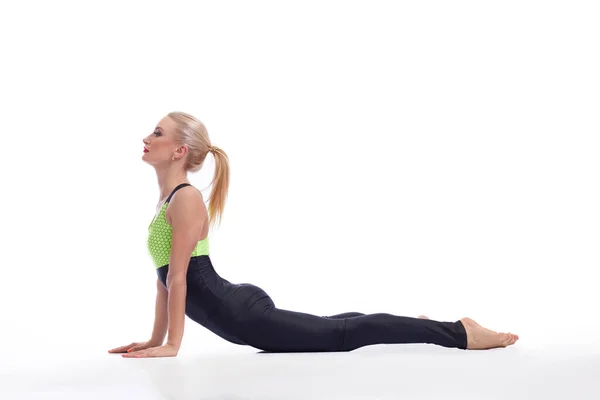 Attractive female gymnast exercising at studio — Stock Photo, Image