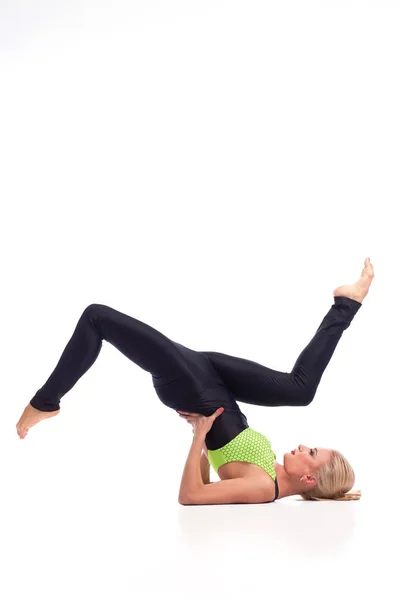 Attractive female gymnast exercising at studio — Stock Photo, Image