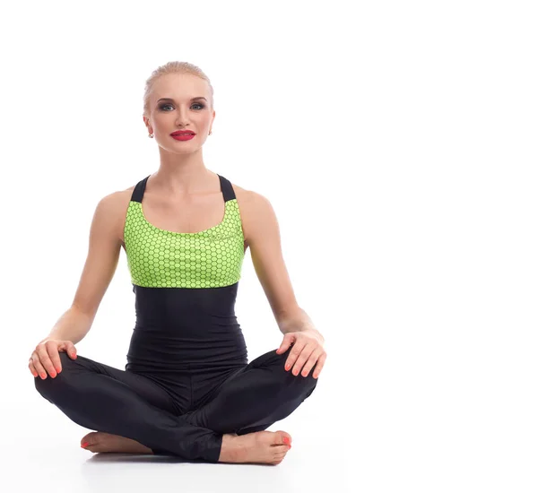 Gorgeous young woman practicing yoga sitting on the floor — Stock Photo, Image