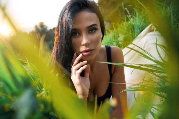 Junge Frau posiert im Gras. — Stockfoto