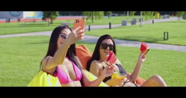 Mayolu mutlu kadınlar cep telefonundan selfie çekiyor.