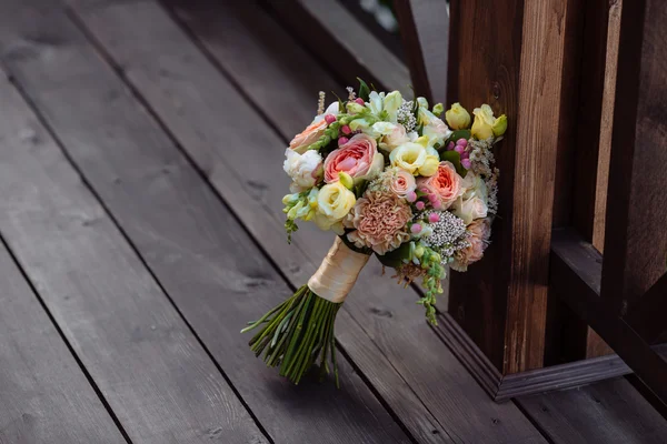 Wedding bouquet. Brides flowers on wooden background