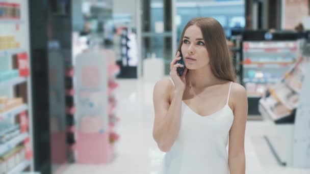 Sociable hermosa mujer caucásica joven se comunica en el teléfono inteligente — Vídeos de Stock