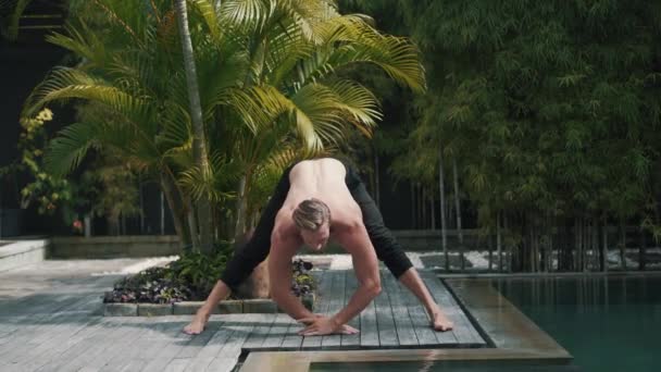 Fitness caucásico hombre deportivo haciendo yoga y estiramiento de los músculos. — Vídeos de Stock