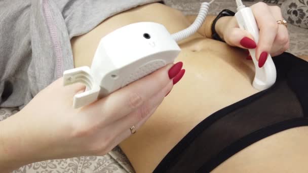 Close-up pregnant woman listening to fetal heart sound through pocket fetal doppler on a bed — Stock Video