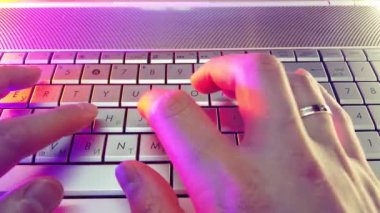 First-person view, hands type text on laptop keyboard