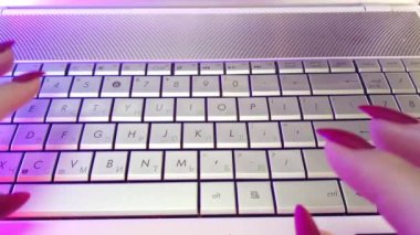 First-person view, hands type text on laptop keyboard