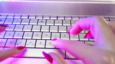 First-person view, hands type text on laptop keyboard