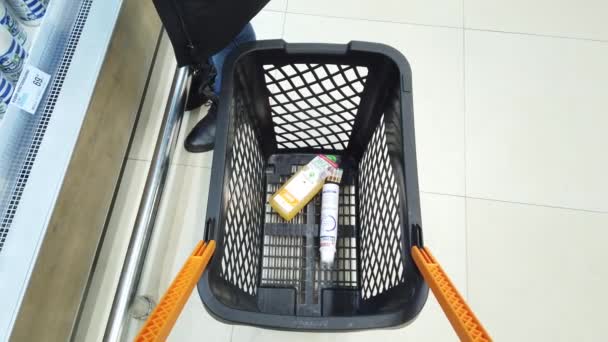 Supermarket Shoppers Put Groceries Trolley — Stock Video