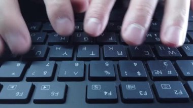 PC klavyesinde erkek eller, yakın çekim, adam hızlı bir şekilde metin yazar. Bilgisayarda ofis ya da ev işi kavramı.