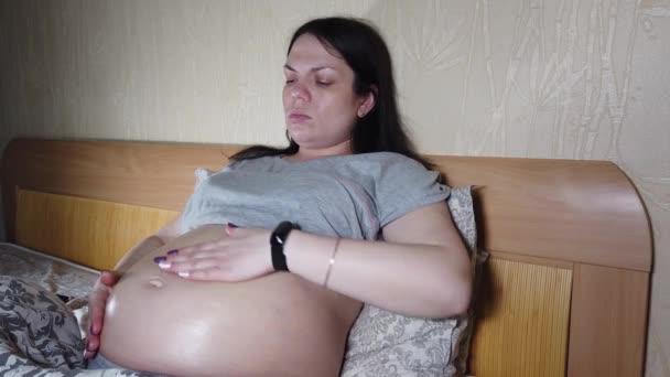 Pragnancy vrouw lotion op buik. Hydratatie van de buik tijdens de zwangerschap door striae — Stockvideo