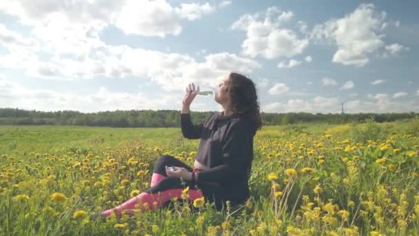 A pregnant girl is resting in a field with beautiful yellow flowers — Stock Video