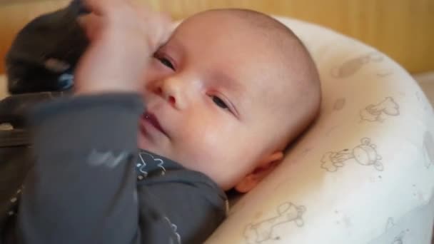 Kleine schattige baby met blauwe fopspeen in de mond, close-up portret — Stockvideo