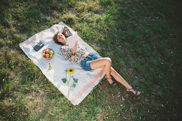 Çim üzerinde yalan ve kitap okuma kız