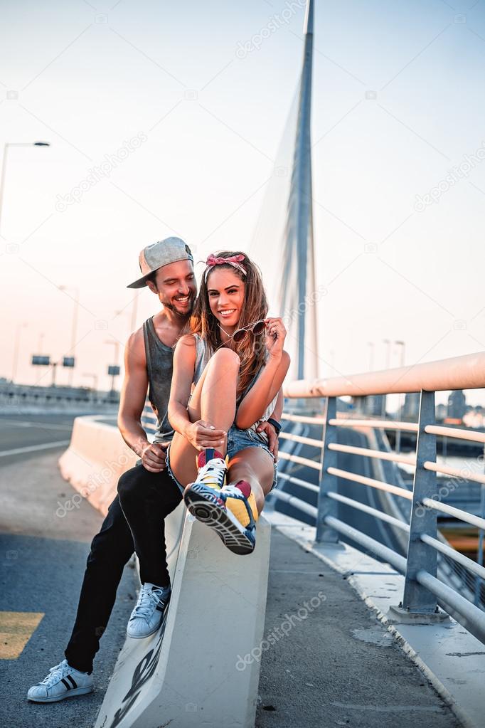 Couple in love sitting by the street