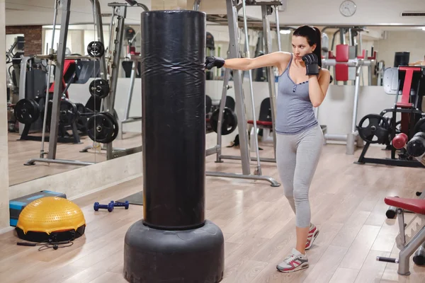 Girl punching bag with hand — Stock Photo, Image