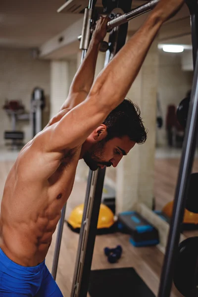 Tired man hanging from the bar — Stock Photo, Image