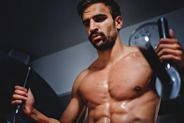 Tired man in the gym looking down