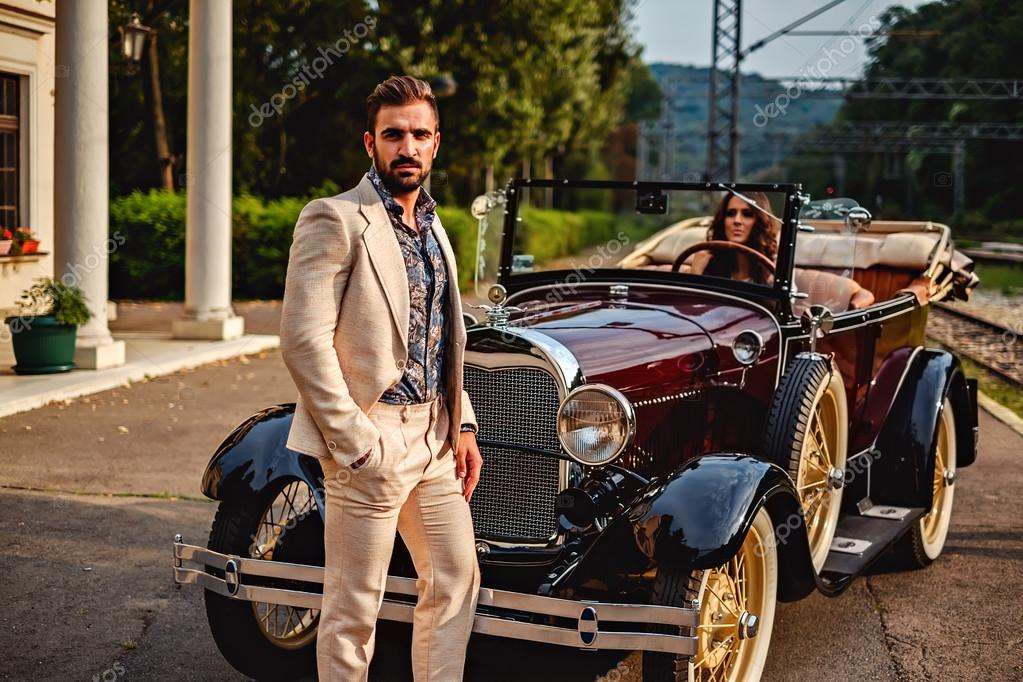 Man Standing In Front Of A Woman In A Classic Car Stock Photo By C Sasamihajlovic 123220144