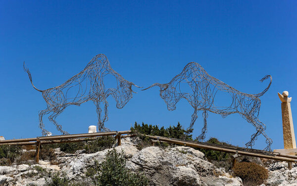 Ayia Napa, Cyprus - July 2019: Silhouettes of two beeches made of metal wire in the Sculpture Park in Ayia Napa. Landmark of Cyprus.