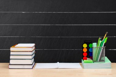 Okul yönetim kurulunun arka planında masanın üzerinde bir yığın ders kitabı ve ofis malzemesi var. Yukarıdaki ögeler için boş alan.