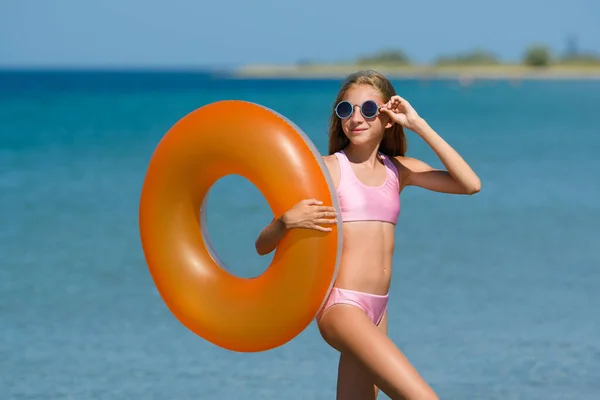 Красивая Девушка Надувным Оранжевым Кругом Солнечных Очках Позирует Пляже Счастливая — стоковое фото
