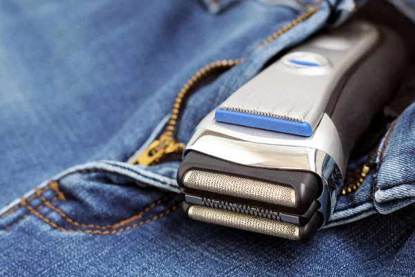 Electric shaver on a jeans so close