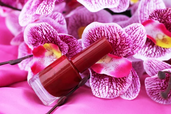 Nail polish with pink orchid flower so close