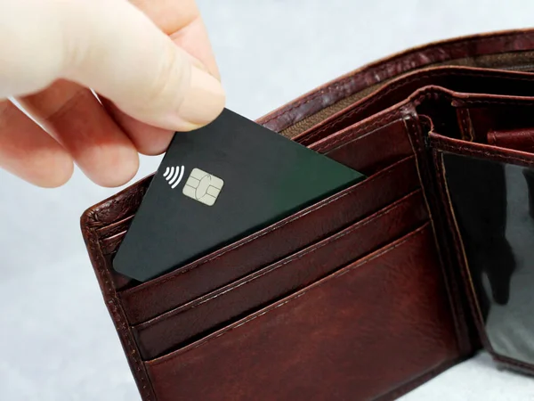 Brown wallet with Credit card so close