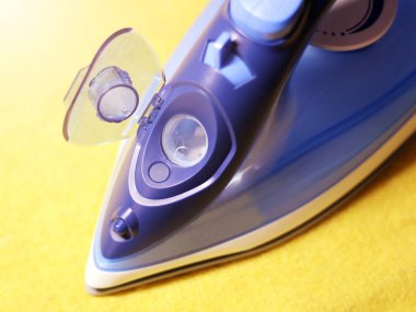 Sarı arkaplandaki elektrik ütüsünü kapat, nesne