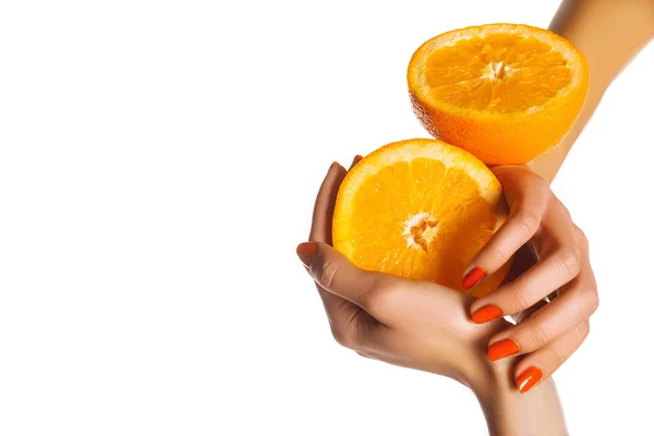 Orange slice in the women's hands with a tattoo. Manicure orange. On a white background — Stock Photo, Image