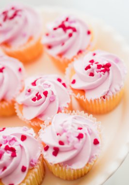 Pembe krema ve kalp sprinkles ile cupcakes