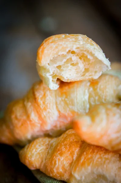 Fresh croissant on wooden background — Stock Photo, Image