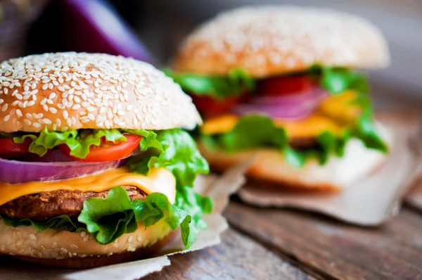 Closeup of home made burgers on wooden background