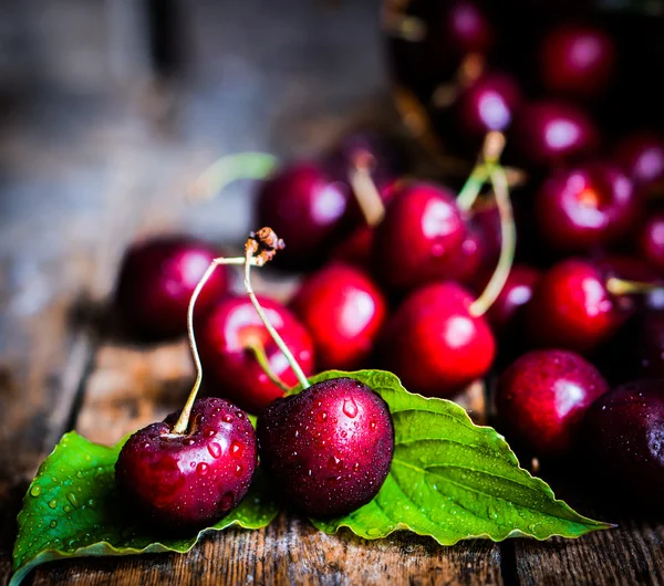 Cherries on rustic wooden background — Stock Photo, Image