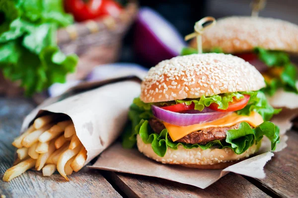 Closeup of home made burgers on wooden background