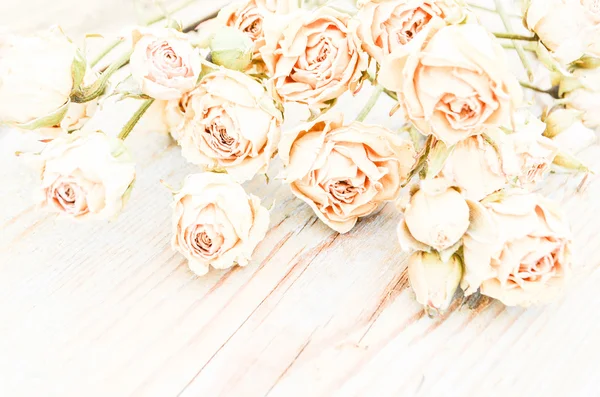 Withered rose on wood