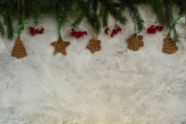 Noel arkaplanı köknar ağacı, örgü oyuncaklar, kırmızı böğürtlenler. Üst görünüm, boşluğu kopyala. Noel ve Yeni Yıl kompozisyonu.