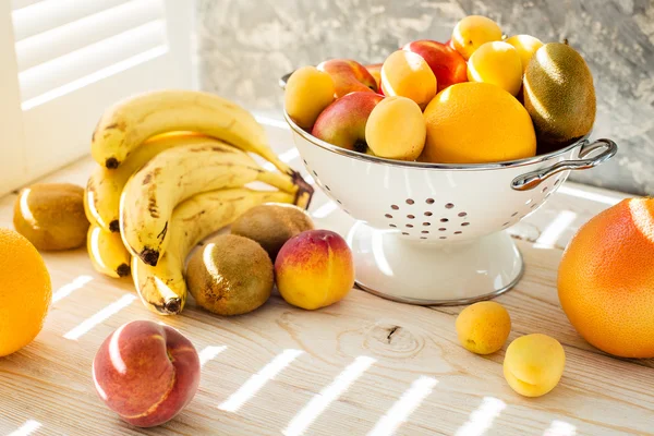 Frische gemischte Früchte in Schale auf hellem Untergrund — Stockfoto